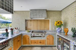 a kitchen with a sink and a stove top oven at Casa Talavera by Tasman in Mexico City