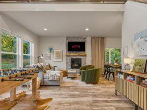 a living room with a large game table in the middle at Rainier Spa Cabin 7 Minutes to Park in Ashford
