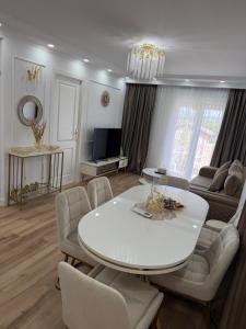 a living room with a white table and chairs at Villa Mery Montserrat in Piera