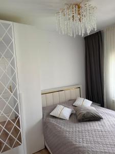a bedroom with a bed and a chandelier at Villa Mery Montserrat in Piera +17 photos