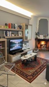a living room with a television and a fireplace at The Dream in Marina di Carrara