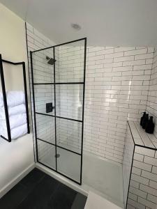 a bathroom with a shower with a glass door at Cozy Catskill Escape in Catskill +8 photos