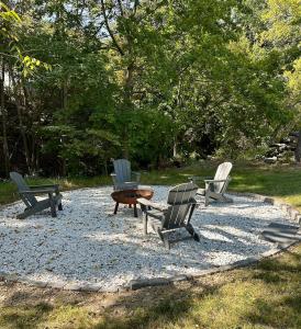 a group of chairs and a table on a gravel patio at Cozy Catskill Escape in Catskill