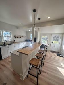 a large kitchen with a large island with bar stools at Cozy Catskill Escape in Catskill