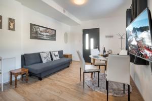 a living room with a couch and a dining room at Mountain Chalet Bergblick Top 2 in Fieberbrunn
