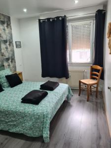 a bedroom with two beds and a blue curtain at Gambetta Insolite in Chambéry