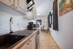 a kitchen with a sink and a counter top at Mountain Chalet Bergblick Top 2 in Fieberbrunn