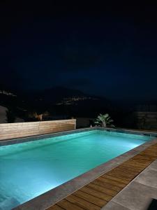 a swimming pool lit up at night at Studio Redin in Savièse