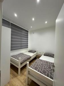 a bedroom with two beds and a window at MiR in Stolac