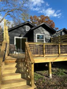 a wooden deck in front of a house at Modern cabin retreat in Catskill