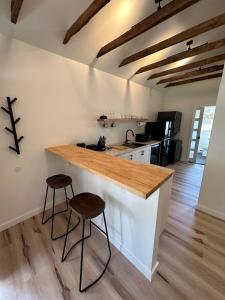 a kitchen with a counter and two stools at Modern cabin retreat in Catskill