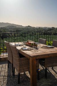 a wooden table with chairs and a bowl of fruit at Barkala Mula in Artá