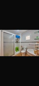 a bathroom with a shower and a toilet and a tub at Residence oum kaltoum in Oued Laou