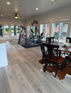 a fitness room with a table and a gym at Private Luxury Pool House Retreat in Lake Charles