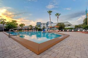 a swimming pool at a resort with palm trees at Holiday Inn Orlando International Dr-ICON by IHG in Orlando