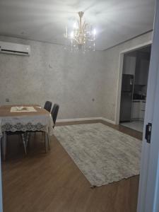 a dining room with a table and a chandelier at Jasmin Park in Baku +10 photos