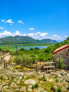 a view of a lake and mountains in the distance at Hana Skadar Lake - 200 metara do jezera in Prevlaka
