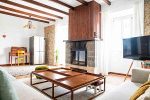 a living room with a fireplace and a table at Barkala Mula in Artá