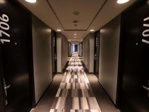 a hallway with a long row of elevators in a building at Mercure Santiago Centro in Santiago +86 photos