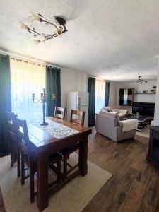 a living room with a dining table and a couch at Apartman Soldat in Šipovo