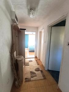 a room with a hallway with a door and a trash can at Apartman Soldat in Šipovo +9 photos