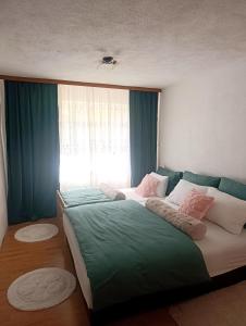 a bedroom with two beds and a window at Apartman Soldat in Šipovo