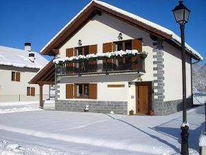 Casa con balcón con nieve en Casa Rural Irugoienea, en Espinal-Auzperri