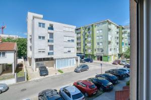 a view of a street with cars parked in a parking lot at V&V apartment in Podgorica