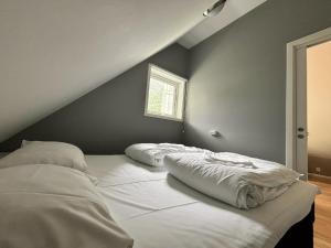 a bed with two pillows on it in a room at Undredal Fjord Apartments in Undredal