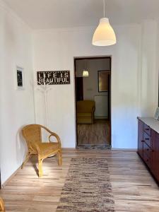 a living room with a chair and a table at LaBONI Apartman in Miskolctapolca