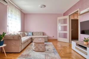 a living room with a couch and a tv at V&V apartment in Podgorica +14 photos