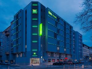 a tall blue building with green lights on it at ibis Styles Lyon Centre Confluence in Lyon