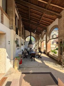 a large building with a patio with a table and chairs at Agriturismo Cipolli e Podò Corte Carlini in Mantova