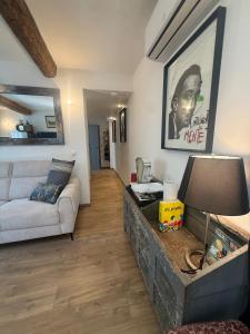 a living room with a couch and a table with a lamp at Entre Pic et Rivière in Saint-Martin-de-Londres