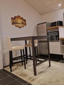 a dining room table with two chairs and a microwave at Wonderfully unique accommodation in Bålsta