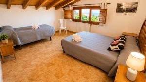 a living room with two beds and a couch at Pensión San Cristóbal by Bossh! Hotels in Cuenca