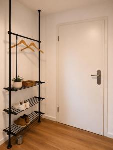 a shelf in a room next to a door at Modernes Appartement mit Balkon & Parkplatz - Waldshut-Tiengen in Waldshut-Tiengen +4 photos
