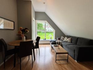 a living room with a couch and a table at Undredal Fjord Apartments in Undredal