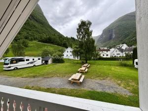 a rv parked in a field with a picnic table at Undredal Fjord Apartments in Undredal