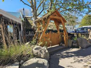 a wooden entrance to a house with a fence at Eco Retreat Saunahaus in Putgarten