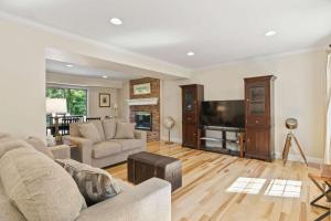 a living room with a couch and a flat screen tv at Spacious Edgewater Home Deck & Sleeps 10 in Edgewater