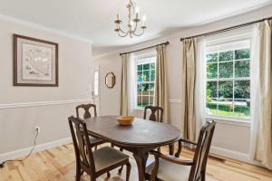 a dining room with a table and chairs at Spacious Edgewater Home Deck & Sleeps 10 in Edgewater +17 photos