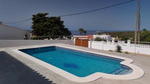 a swimming pool on top of a house at Villa Vistamar - Piscina privada, vistas al mar y a 5 min de la playa in Cala en Porter