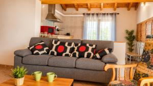a living room with a gray couch with pillows on it at Pensión San Cristóbal by Bossh! Hotels in Cuenca
