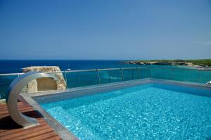 a swimming pool with a view of the ocean at Hotel Belvedere in Torre dell'Orso