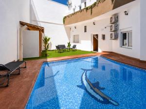 a swimming pool in the middle of a house at Sanchis Studios in Alicante