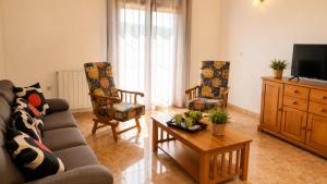 a living room with a couch and chairs and a tv at Pensión San Cristóbal by Bossh! Hotels in Cuenca