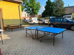 a ping pong table in a parking lot with parked cars at Konvoj szálló in Budapest