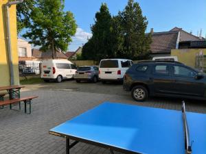 a ping pong table in a parking lot with parked cars at Konvoj szálló in Budapest