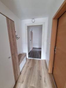 an empty room with a door and a hallway at Apartma 8 in Pekre